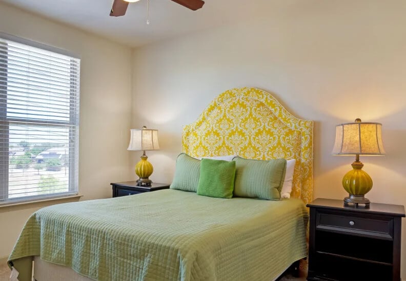 Comfortable Bedroom With Yellow Headboard at Senior Living Cottages Comfortable Bedroom With Yellow Headboard at Senior Living Cottages